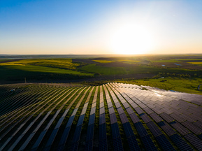 A Solar Park with the sun in the background