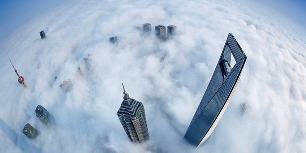 Aerial view of skyscrapers reacing above a layer of a stratus cloud