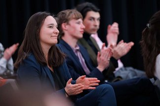  Katharina Meissner-Schöller from the city of Vienna and other audience members clapping after a presentation