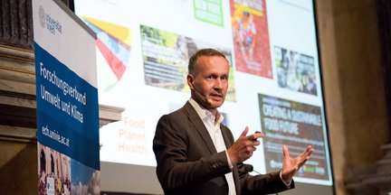 Thilo Hofmann delivering the keynote at Environmental Dialogue 9, with a presentation on sustainable food futures displayed behind him.