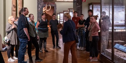 Participants gathered around a guide during a pre-event tour of the Natural History Museum Vienna.