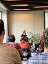 ECH Co-Director Sabine Pahl standing in front of the ECH members and giving a talk.