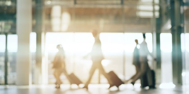 People moving on an airport with suitcases