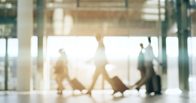 People moving on an airport with suitcases