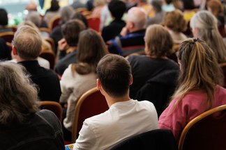 Back view of the audience listening to the lecture