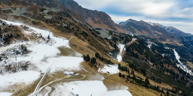 The "Obertauern" skiing region in Austria in winter. Brown hills with artificial snow where the slopes are in between.