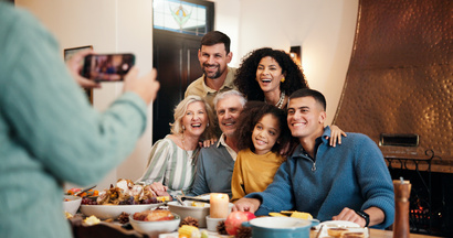 A family taking a picture while sharing a meal