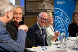 The panel members smiling at each other