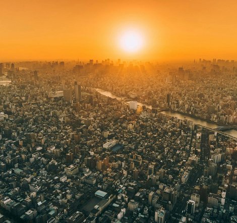 Aerial view of a city with the sunset in the background.