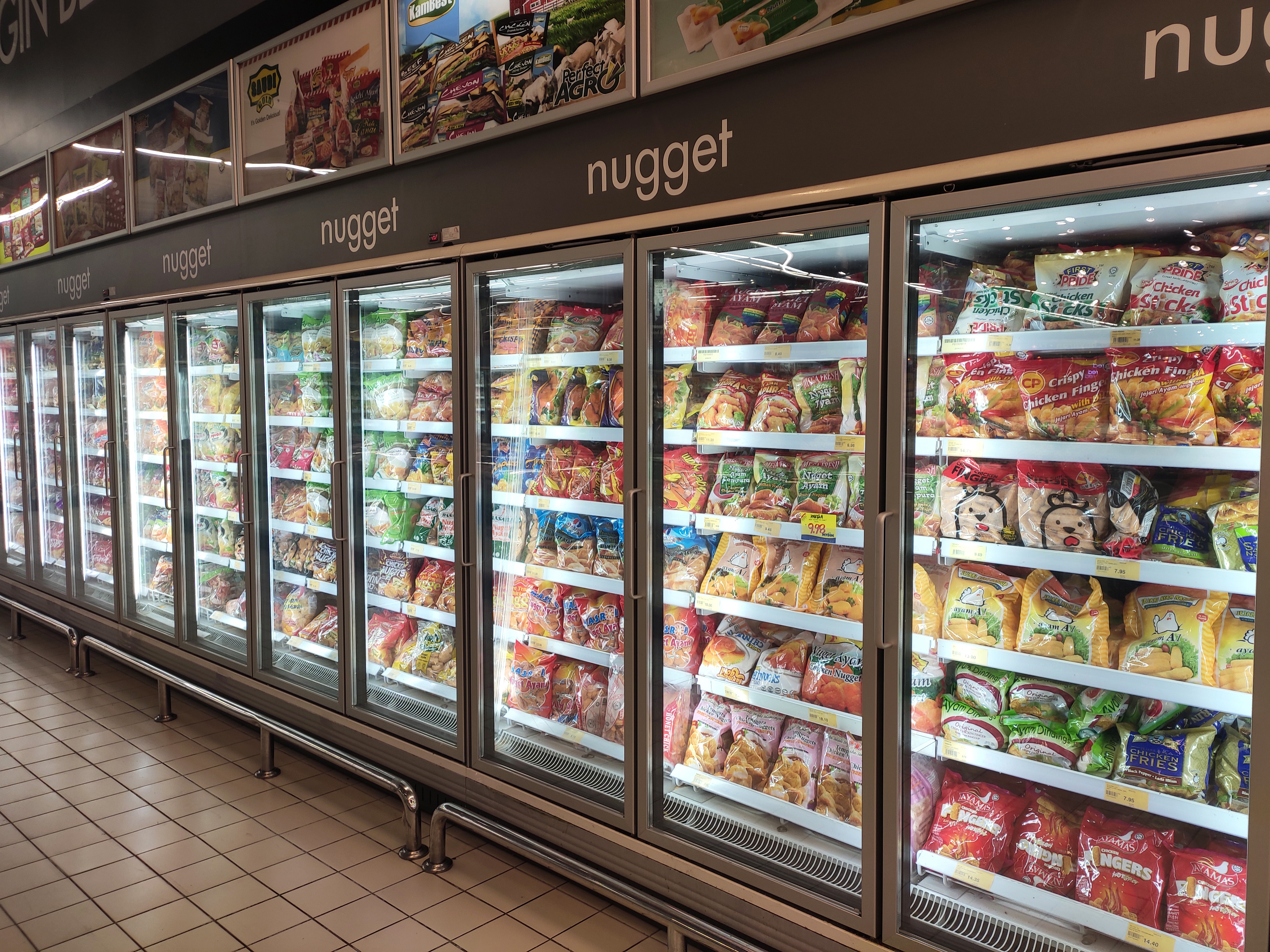 Freezer shelfs in a supermarket filled with highly processed foods