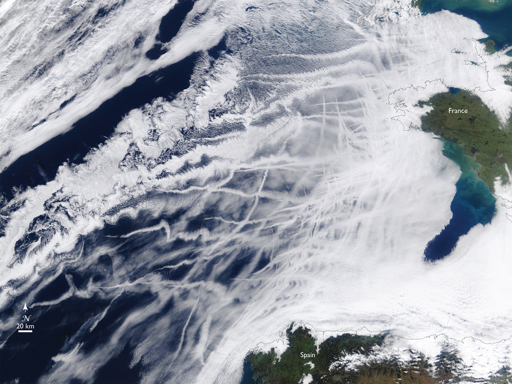 Satellite image of aircraft contrails over the Atlantic Ocean near France and Spain.
